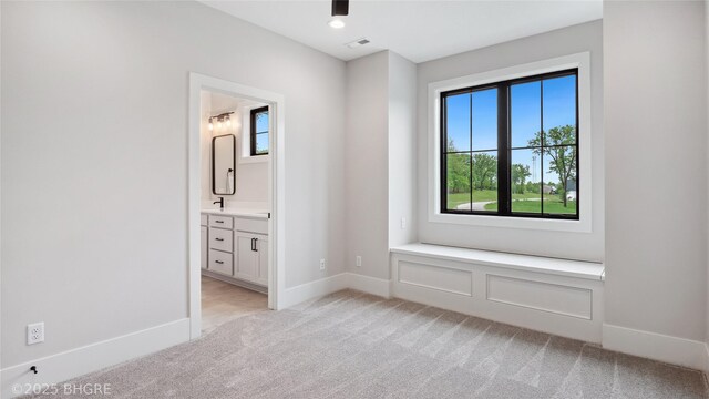 815 S Kingswood Ct, West Des Moines, IA 50266 - unfurnished bedroom featuring light colored carpet, ensuite bath, baseboards, and a sink