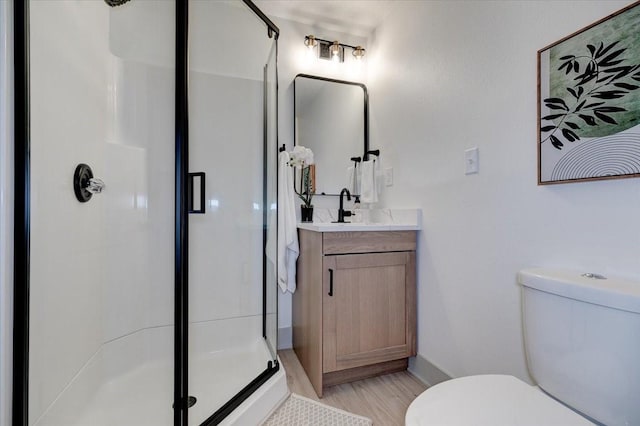 801 SE 5th St, Grimes, IA 50111 - bathroom featuring toilet, a shower stall, vanity, wood finished floors, and baseboards