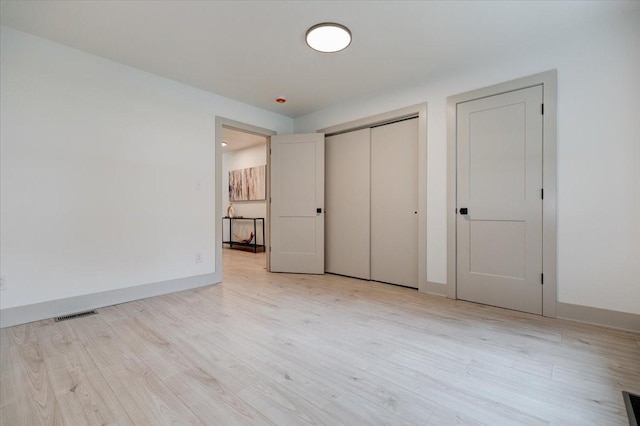 801 SE 5th St, Grimes, IA 50111 - unfurnished bedroom with light wood-type flooring, baseboards, and a closet