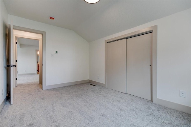 801 SE 5th St, Grimes, IA 50111 - unfurnished bedroom featuring lofted ceiling, carpet floors, a closet, and baseboards