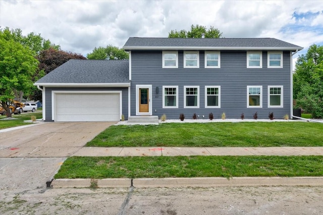 801 SE 5th St, Grimes, IA 50111 - colonial home featuring a garage, driveway, a front lawn, and roof with shingles