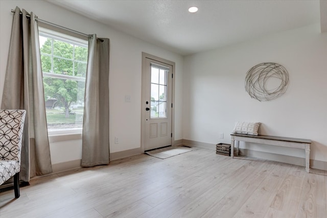 801 SE 5th St, Grimes, IA 50111 - foyer entrance featuring healthy amount of natural light, wood finished floors, baseboards, and recessed lighting