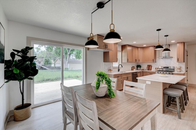 801 SE 5th St, Grimes, IA 50111 - dining room with light wood-style flooring, recessed lighting, and a textured ceiling
