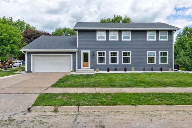 801 SE 5th St, Grimes, IA 50111 - colonial home featuring an attached garage, driveway, a front lawn, and roof with shingles