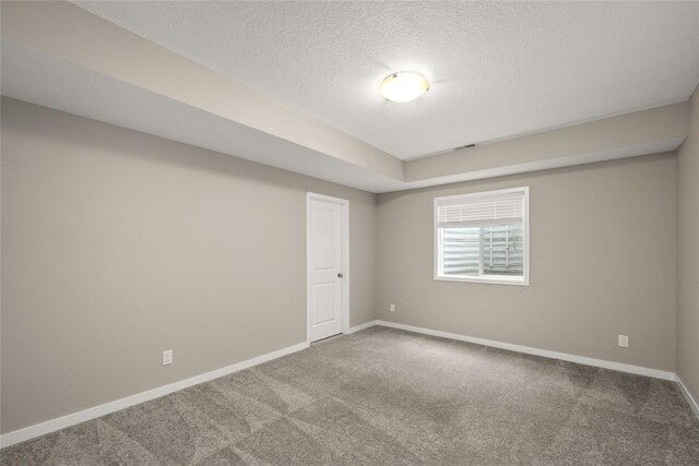 9334 Valley Pkwy, Johnston, IA 50131 - carpeted spare room featuring baseboards and a textured ceiling
