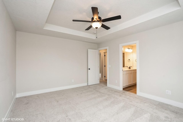 2925 6th Ave SW, Altoona, IA 50009 - unfurnished bedroom featuring a raised ceiling, carpet flooring, and baseboards