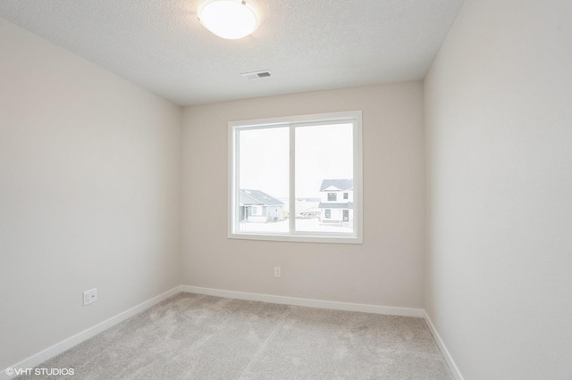 2925 6th Ave SW, Altoona, IA 50009 - carpeted spare room featuring baseboards and a textured ceiling