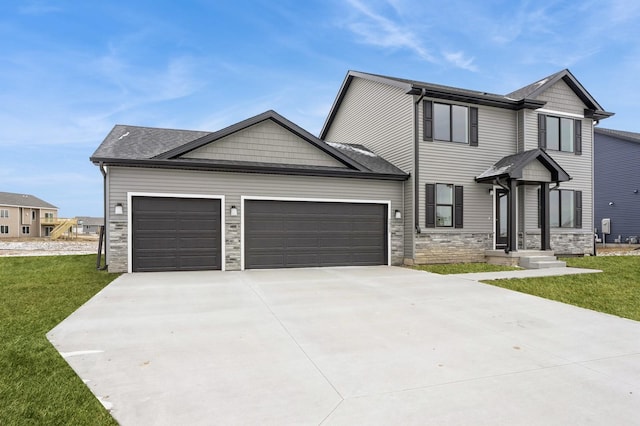 2925 6th Ave SW, Altoona, IA 50009 - view of front of home featuring an attached garage, stone siding, concrete driveway, and a front lawn