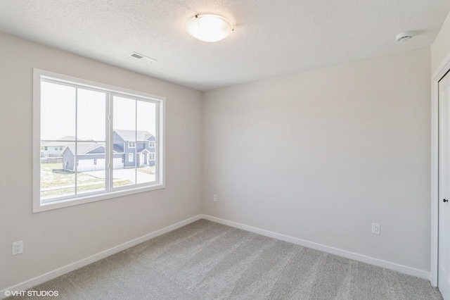 3010 6th Ave SW, Altoona, IA 50009 - empty room featuring light colored carpet, baseboards, a smoke detector, and a textured ceiling