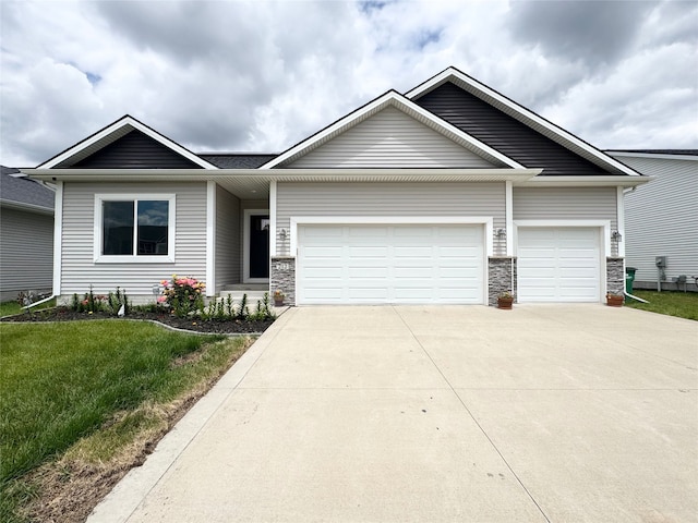 212 6th St NE, Bondurant, IA 50035 - view of front facade with an attached garage, driveway, a front lawn, and stone siding