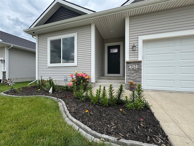 212 6th St NE, Bondurant, IA 50035 - property entrance with a garage