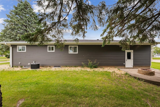204 W Washington St, Montezuma, IA 50171 - back of property featuring a fire pit, a yard, and central AC unit