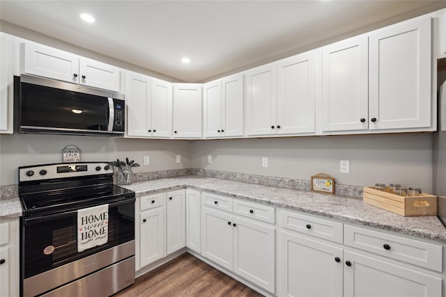 204 W Washington St, Montezuma, IA 50171 - kitchen with stainless steel appliances, white cabinets, wood finished floors, recessed lighting, and light stone countertops
