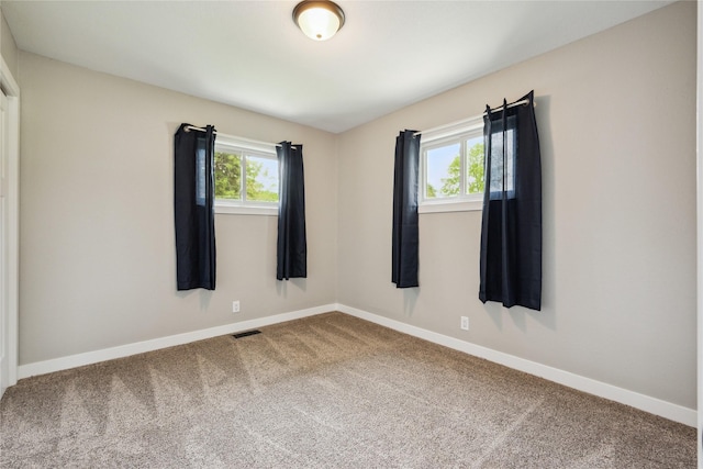 204 W Washington St, Montezuma, IA 50171 - carpeted spare room with plenty of natural light and baseboards
