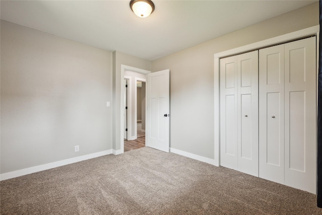 204 W Washington St, Montezuma, IA 50171 - unfurnished bedroom featuring carpet floors, a closet, and baseboards