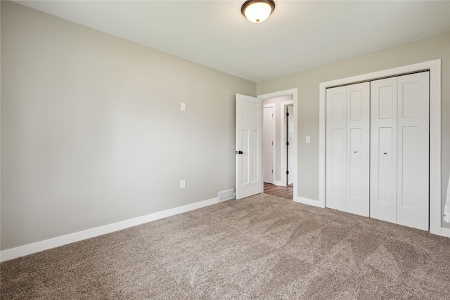 204 W Washington St, Montezuma, IA 50171 - unfurnished bedroom featuring carpet flooring, baseboards, and a closet