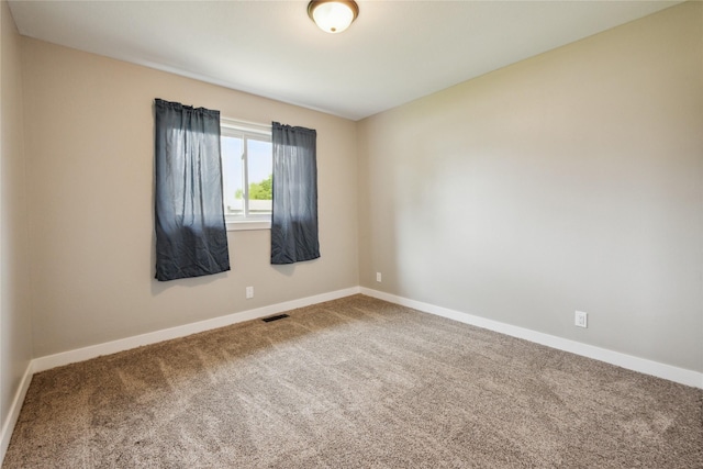 204 W Washington St, Montezuma, IA 50171 - carpeted empty room featuring baseboards