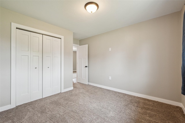 204 W Washington St, Montezuma, IA 50171 - unfurnished bedroom featuring carpet floors, a closet, and baseboards