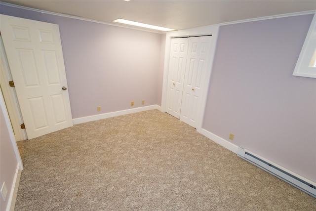 1055 40th St, Des Moines, IA 50311 - unfurnished bedroom with baseboard heating, carpet floors, baseboards, a closet, and crown molding