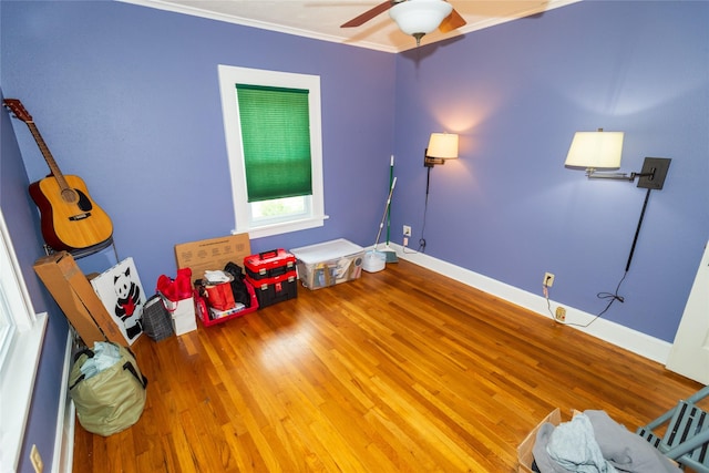 1055 40th St, Des Moines, IA 50311 - recreation room with wood finished floors, ceiling fan, crown molding, and baseboards