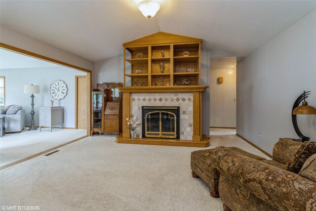 408 W 13th St N, Newton, IA 50208 - carpeted living area featuring vaulted ceiling, a tile fireplace, and baseboards