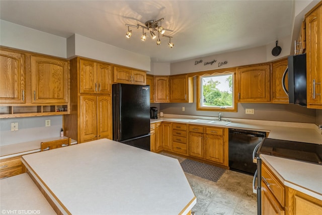 408 W 13th St N, Newton, IA 50208 - kitchen with black appliances, a sink, brown cabinets, and light countertops