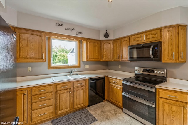 408 W 13th St N, Newton, IA 50208 - kitchen featuring black appliances, a sink, brown cabinets, and light countertops