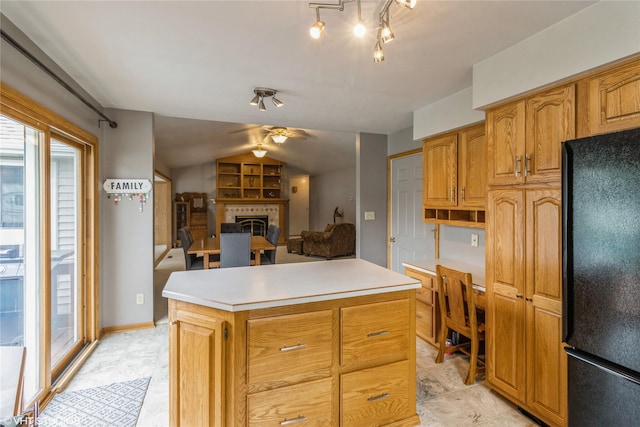 408 W 13th St N, Newton, IA 50208 - kitchen with freestanding refrigerator, ceiling fan, a fireplace, a center island, and light countertops