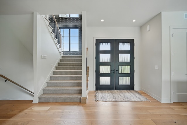 1004 NW Hugg Dr, Polk City, IA 50226 - entrance foyer featuring french doors, wood-type flooring, stairway, baseboards, and recessed lighting