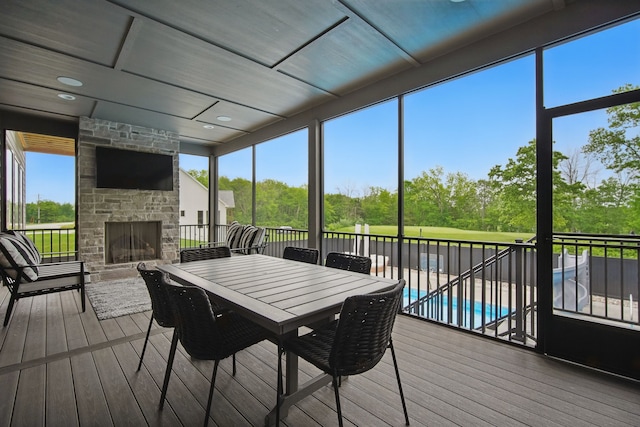 1004 NW Hugg Dr, Polk City, IA 50226 - sunroom / solarium featuring a fireplace and view of wooded area