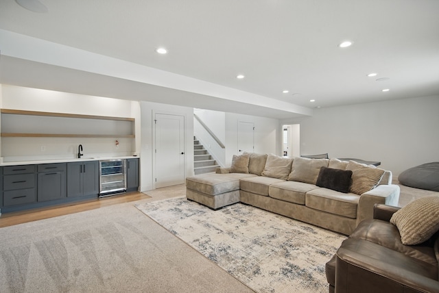 1004 NW Hugg Dr, Polk City, IA 50226 - living room featuring bar with sink, wine cooler, recessed lighting, and stairs
