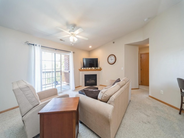 1355 SE 6th St Unit 301, Grimes, IA 50111 - living area with a tile fireplace, light carpet, baseboards, and a ceiling fan