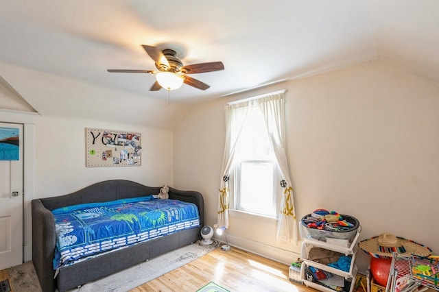 140 N 7th St, Carlisle, IA 50047 - bedroom featuring vaulted ceiling, wood finished floors, and a ceiling fan