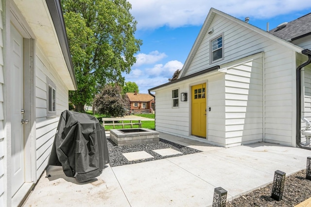 140 N 7th St, Carlisle, IA 50047 - view of patio featuring an outdoor fire pit