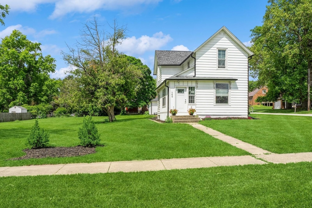 140 N 7th St, Carlisle, IA 50047 - traditional home featuring a front yard and a shingled roof
