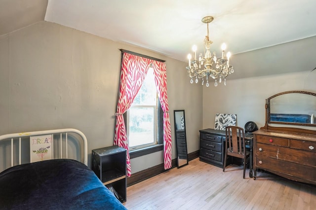 140 N 7th St, Carlisle, IA 50047 - bedroom featuring wood-type flooring and a chandelier