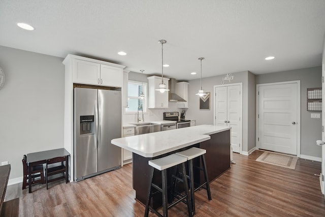 603 Elm Ct, Dallas Center, IA 50063 - kitchen featuring appliances with stainless steel finishes, a center island, light countertops, dark wood-style floors, and white cabinetry