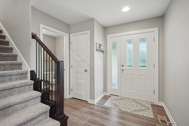 603 Elm Ct, Dallas Center, IA 50063 - foyer entrance with stairway, wood finished floors, and recessed lighting