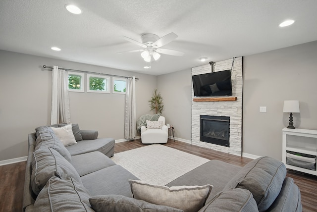 603 Elm Ct, Dallas Center, IA 50063 - living area with a ceiling fan, recessed lighting, dark wood-type flooring, a fireplace, and a textured ceiling