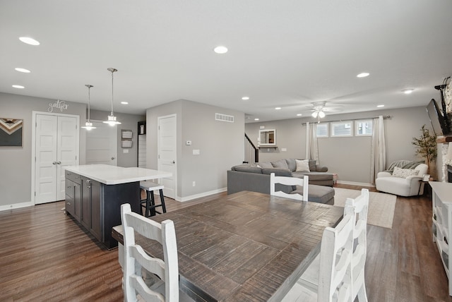 603 Elm Ct, Dallas Center, IA 50063 - dining space with recessed lighting, a ceiling fan, dark wood-style flooring, and stairs
