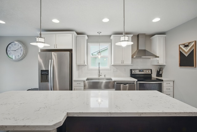 603 Elm Ct, Dallas Center, IA 50063 - kitchen featuring stainless steel appliances, wall chimney range hood, decorative backsplash, white cabinets, and recessed lighting
