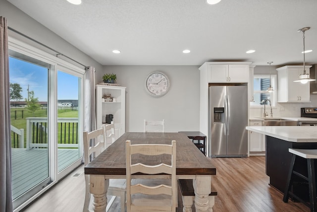 603 Elm Ct, Dallas Center, IA 50063 - dining room featuring light wood finished floors and recessed lighting