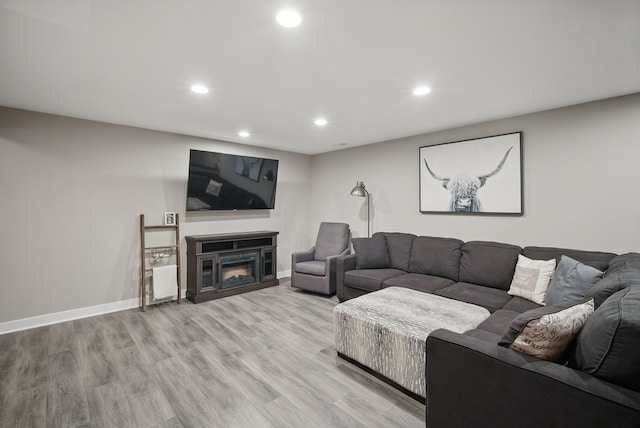 603 Elm Ct, Dallas Center, IA 50063 - living area featuring recessed lighting, light wood-type flooring, and a glass covered fireplace