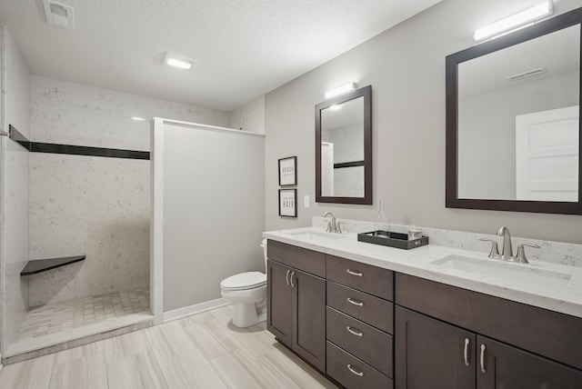 603 Elm Ct, Dallas Center, IA 50063 - full bath featuring double vanity, walk in shower, and a textured ceiling
