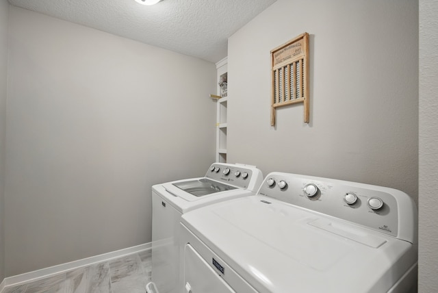 603 Elm Ct, Dallas Center, IA 50063 - laundry room featuring independent washer and dryer, a textured ceiling, and light marble finish floors