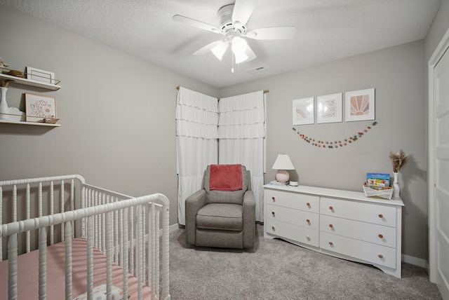 603 Elm Ct, Dallas Center, IA 50063 - bedroom with carpet flooring, a crib, and a ceiling fan
