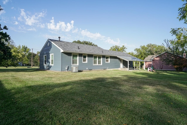 1617 Evergreen Ave, Des Moines, IA 50320 - back of house featuring a lawn and central air condition unit