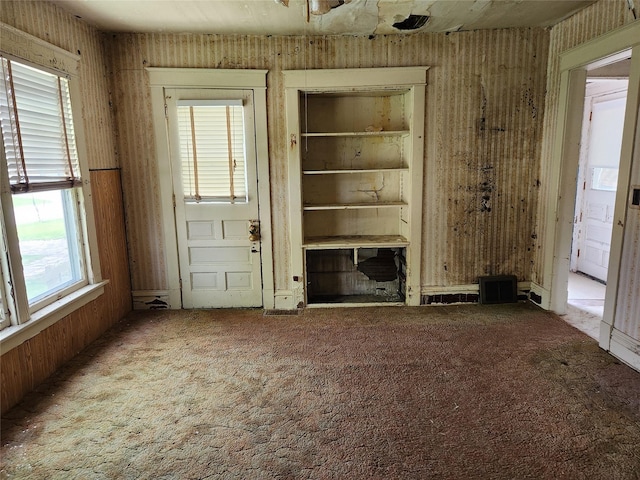 414 E Robinson St, Knoxville, IA 50138 - unfurnished living room featuring carpet floors