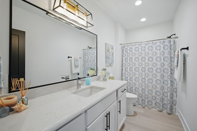 2216 Timberview Dr, Norwalk, IA 50211 - full bathroom with vanity, toilet, a shower with curtain, wood finished floors, and recessed lighting