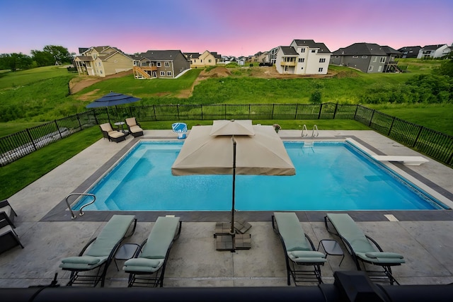 2216 Timberview Dr, Norwalk, IA 50211 - pool at dusk featuring a residential view and a patio